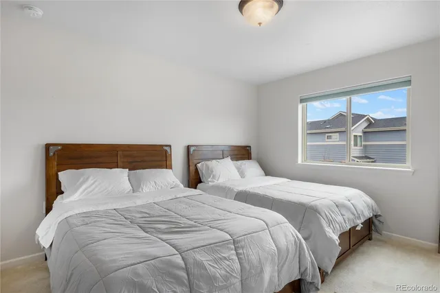 a bedroom with two beds and a walk in closet