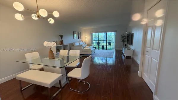 a view of a dining room with furniture and wooden floor
