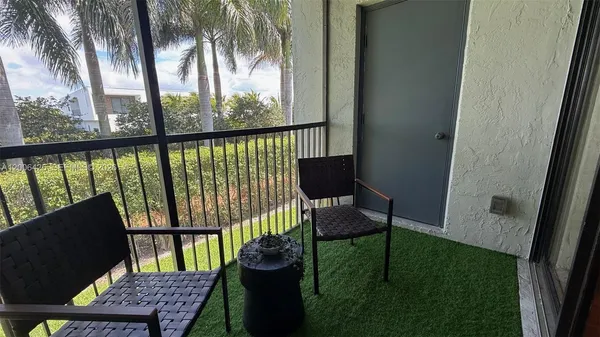 a view of a balcony with furniture
