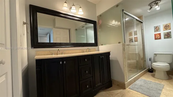 a bathroom with a sink vanity and a mirror