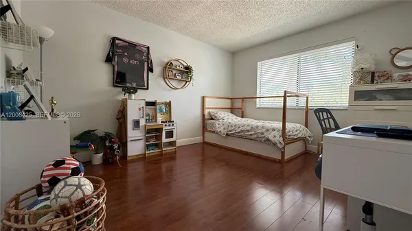 a bedroom with furniture and a window