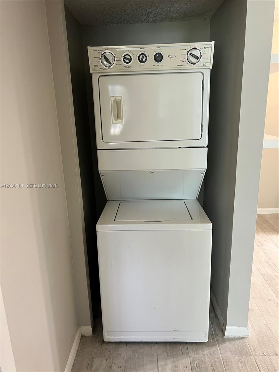 951 Lyons Road, Unit 6104 Coconut Creek, FL 33063 - Photo 6 of 18 a utility room with dryer and washer