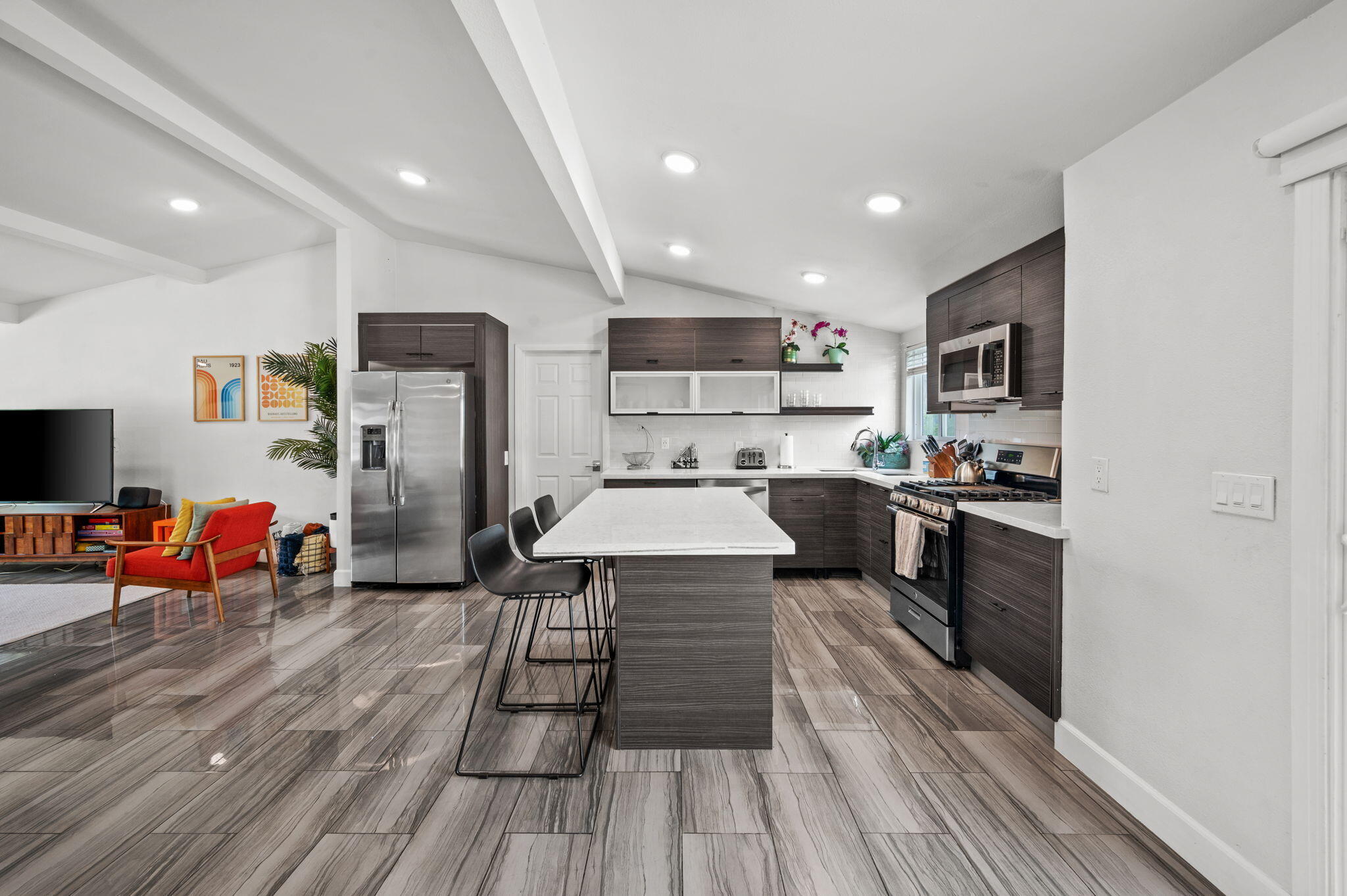 3059 North Biskra Road Palm Springs, CA 92262 - Photo 14 of 44 a kitchen with stainless steel appliances a refrigerator sink and wooden floor