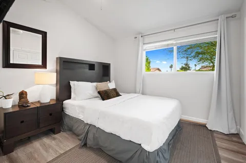 a bedroom with a bed and a window