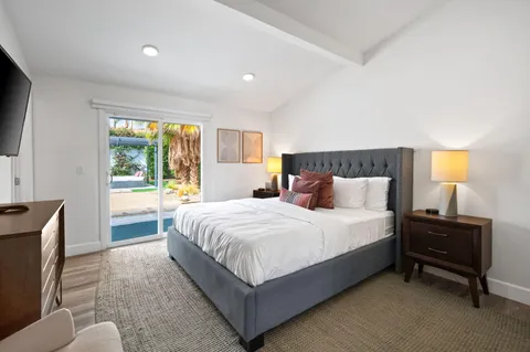 a bedroom with a bed and a couch