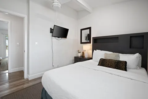 a bedroom with a bed and wooden floor