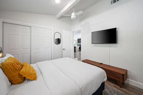 a bedroom with a bed and a flat screen tv