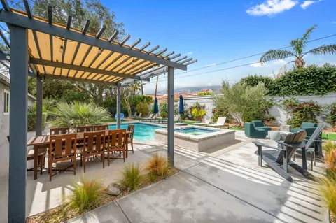 a view of a patio with dining table and chairs with a couches near a patio