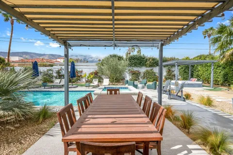 a view of a patio with swimming pool table and chairs