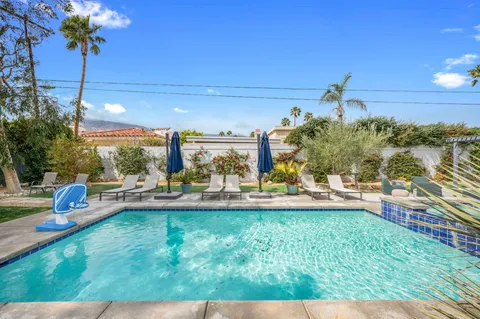 a view of a swimming pool and lounge chairs