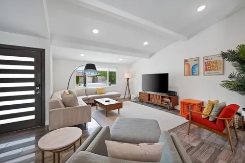 a living room with furniture and a flat screen tv