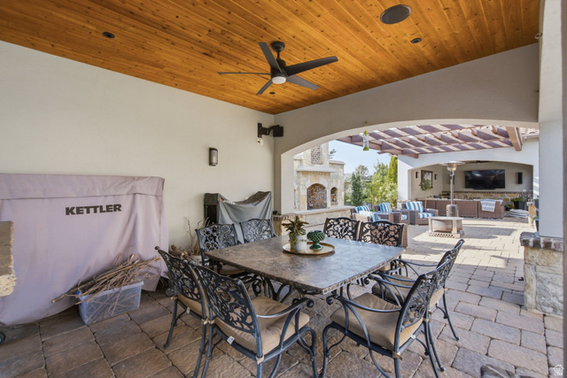 12308 Mariah Circle Draper, UT 84020 - Photo 163 of 293 Covered outdoor dining area featuring a wood-panel ceiling with recessed lighting and a ceiling fan