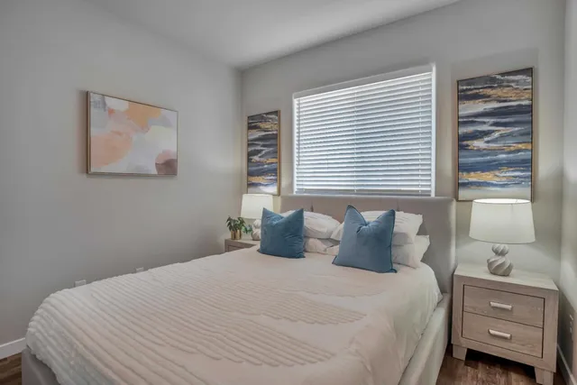 a bedroom with a bed and a window