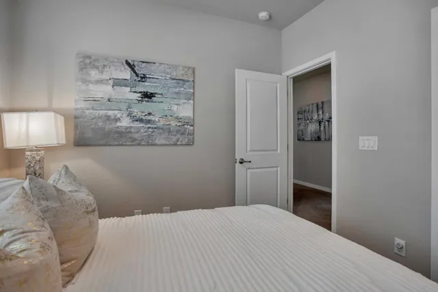 a bedroom with a bed and a lamp