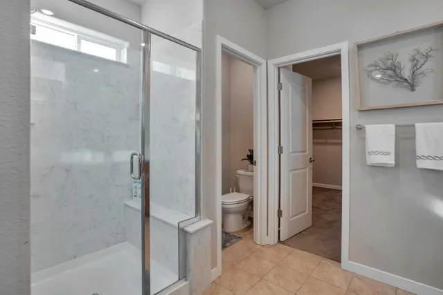 a bathroom with a glass shower door