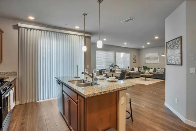 a kitchen with sink stove and refrigerator