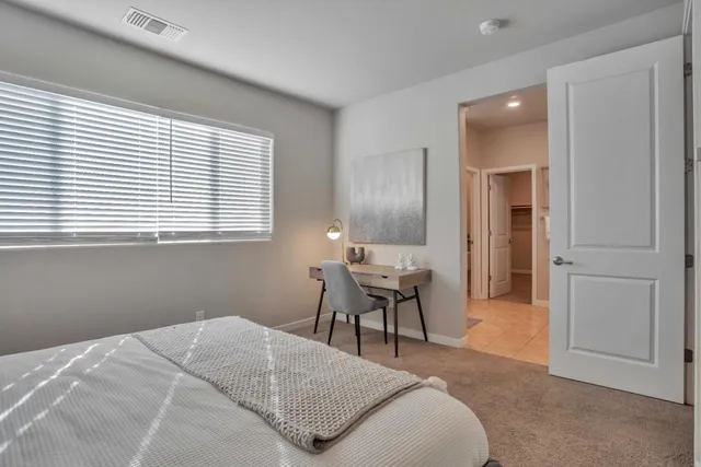 a bedroom with a bed and a table in it