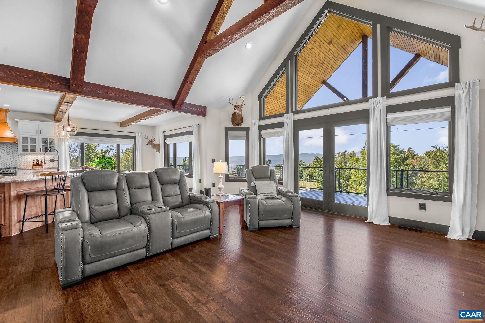 699 Hendrickson Road Pembroke, VA 24136 - Photo 26 of 69 a living room with furniture floor to ceiling window and wooden floor