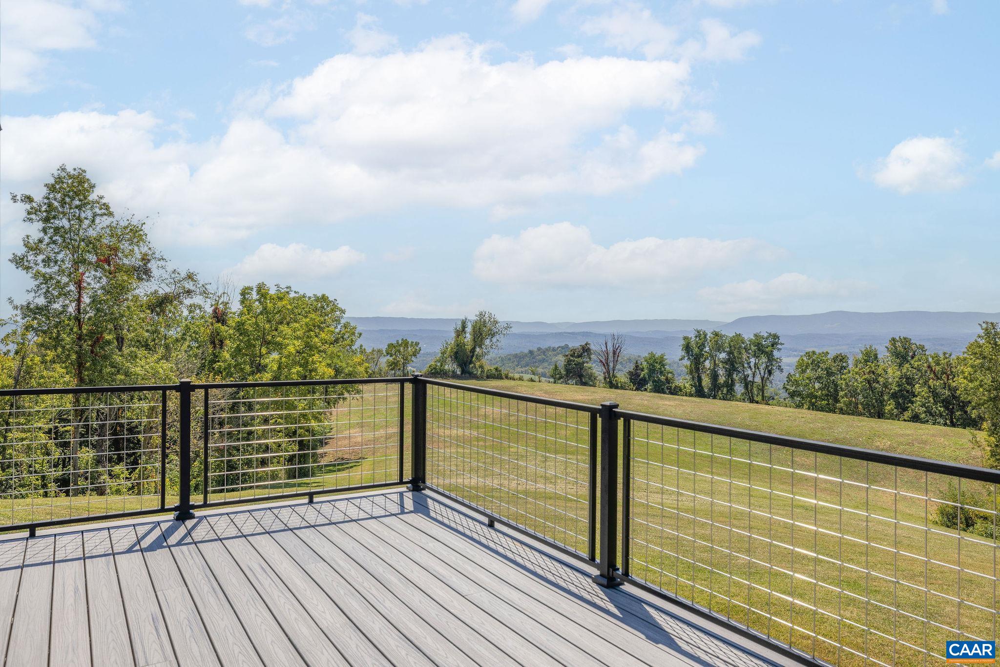 699 Hendrickson Road Pembroke, VA 24136 - Photo 29 of 69 a view of a balcony with wooden floor next to a yard