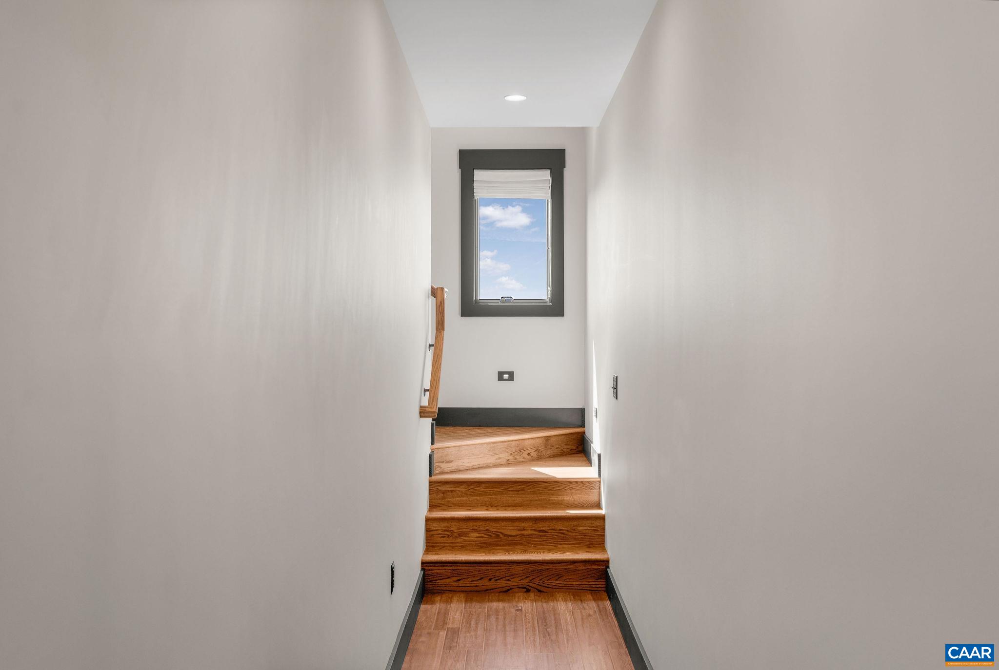 699 Hendrickson Road Pembroke, VA 24136 - Photo 38 of 69 a view of a hallway with wooden floor and a white cabinet