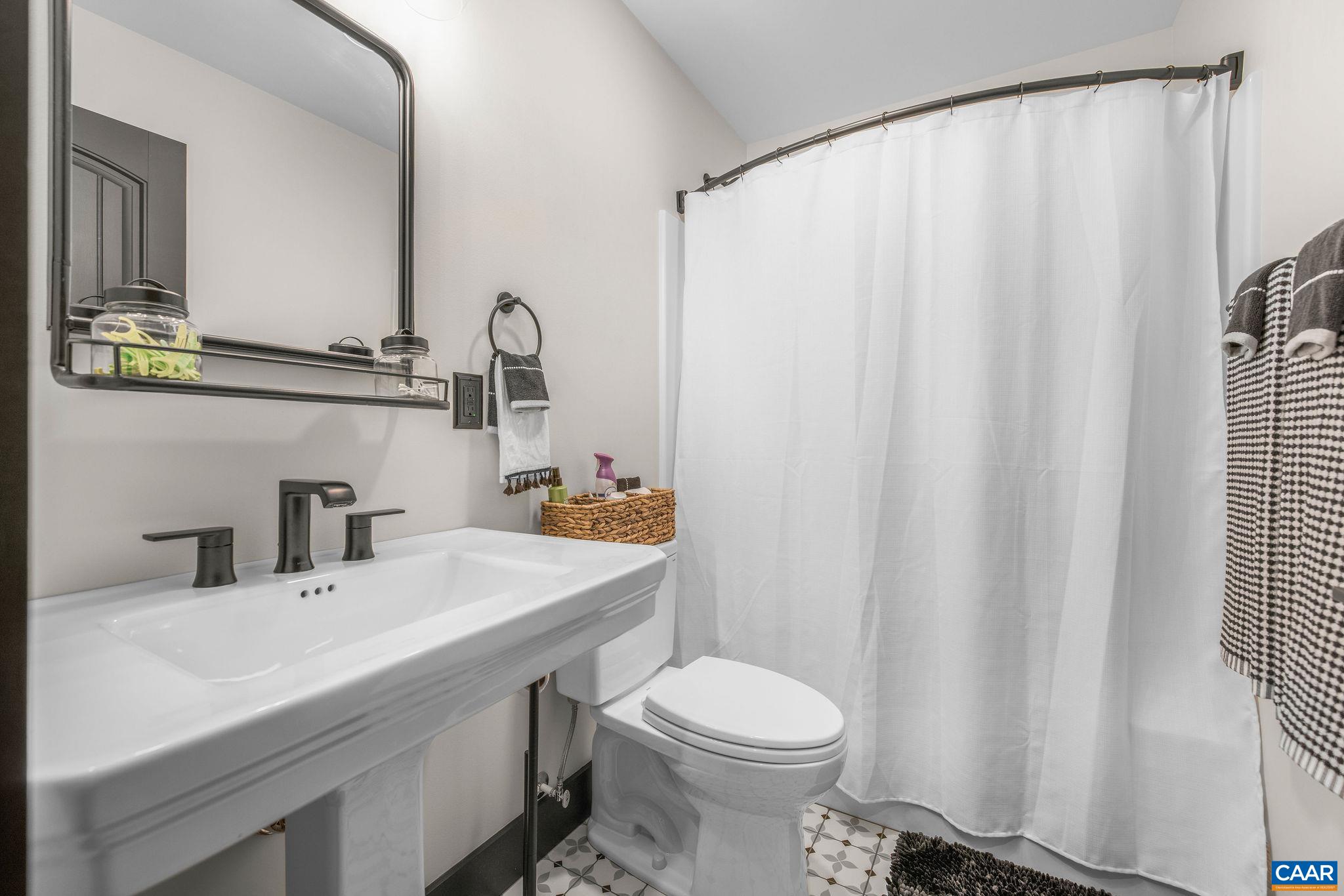 699 Hendrickson Road Pembroke, VA 24136 - Photo 43 of 69 a bathroom with a sink a toilet and mirror