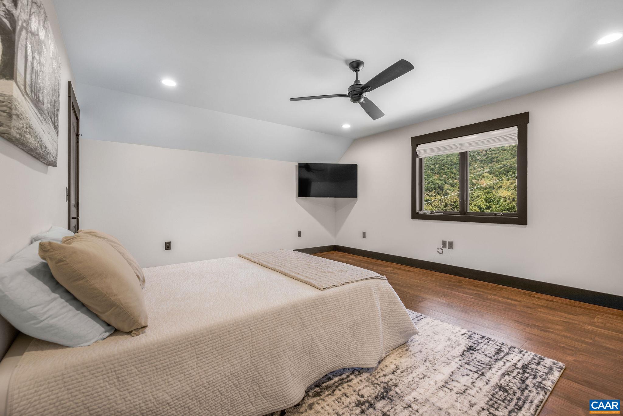 699 Hendrickson Road Pembroke, VA 24136 - Photo 44 of 69 a bedroom with a large bed and a window