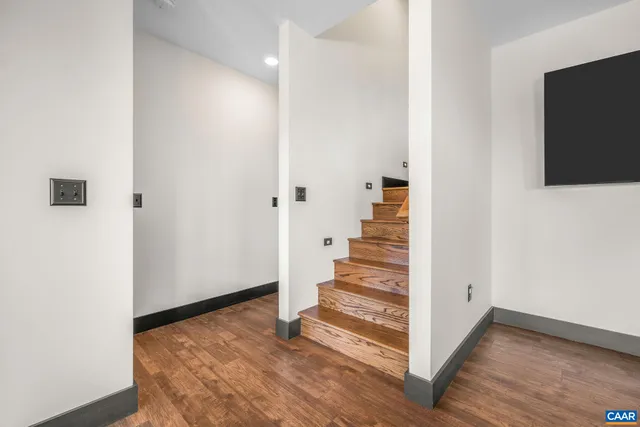 a view of a room with wooden floor