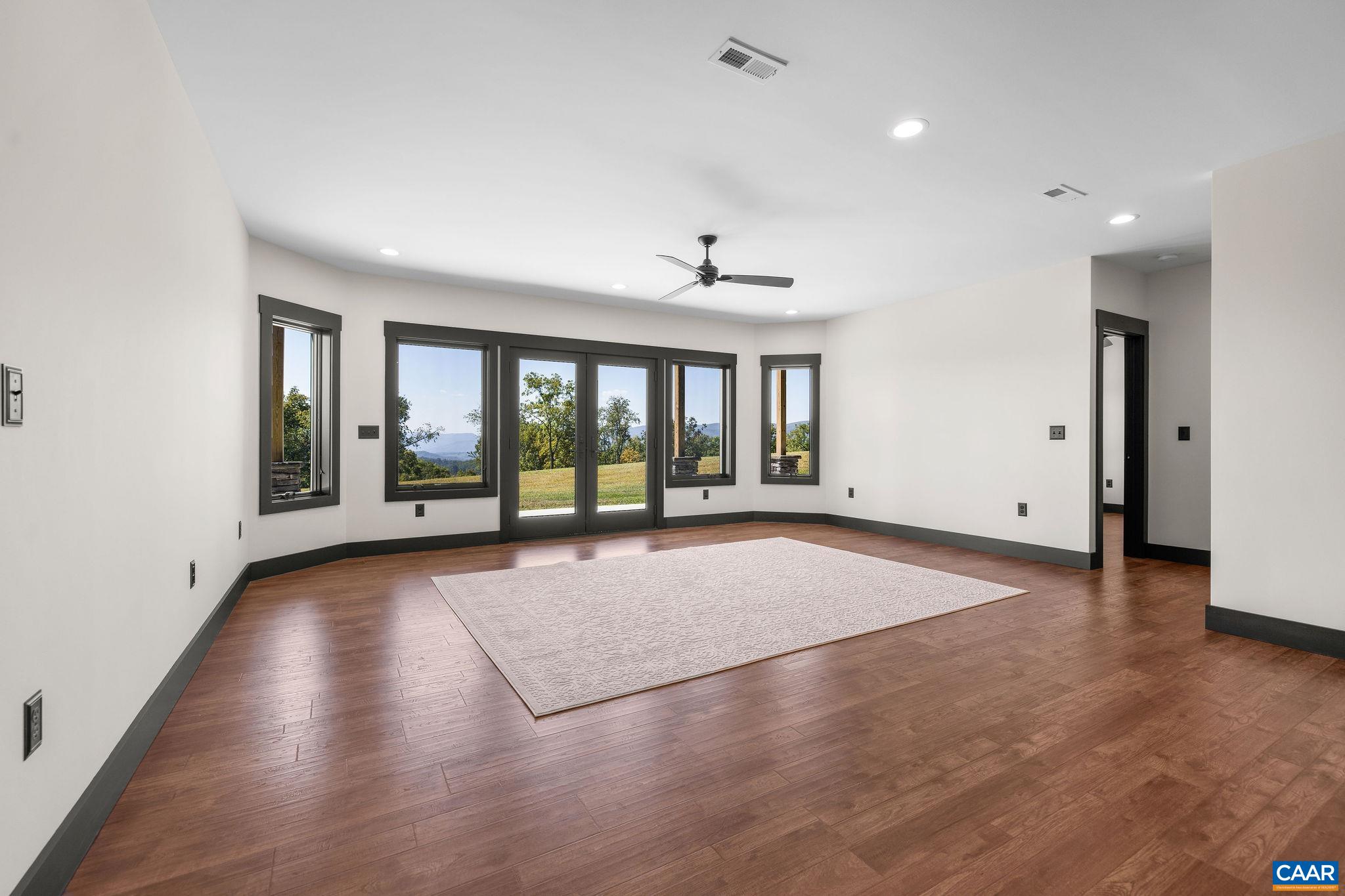 699 Hendrickson Road Pembroke, VA 24136 - Photo 46 of 69 a view of an empty room with a window and wooden floor