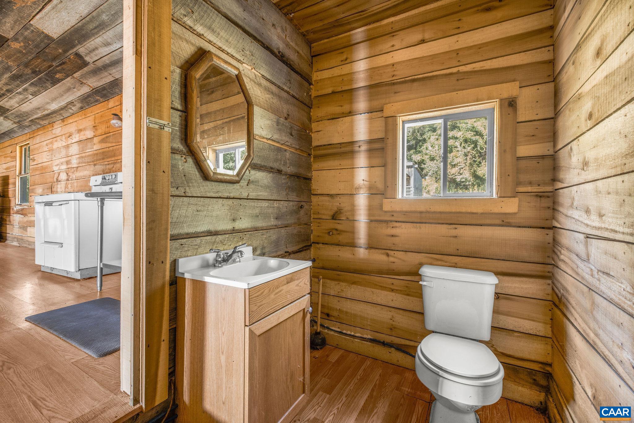 699 Hendrickson Road Pembroke, VA 24136 - Photo 61 of 69 a bathroom with a toilet sink and mirror