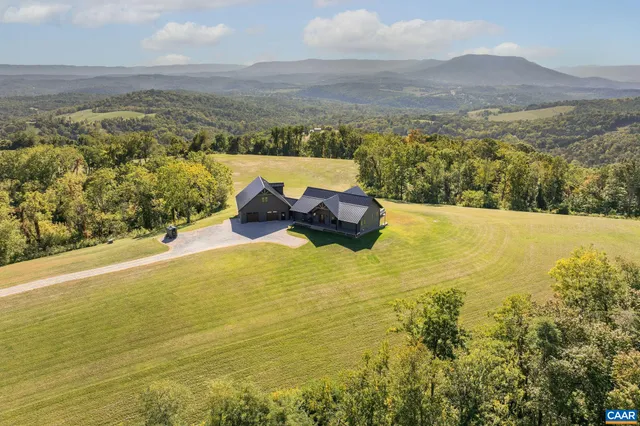 a view of house with outdoor space and sitting area