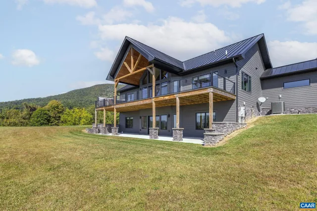 a view of house with a yard and potted plants