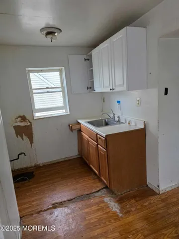 a room with wooden cabinets and a sink