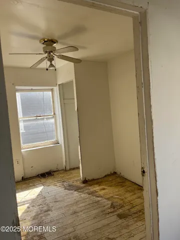 a view of a blue house with a yard and plants