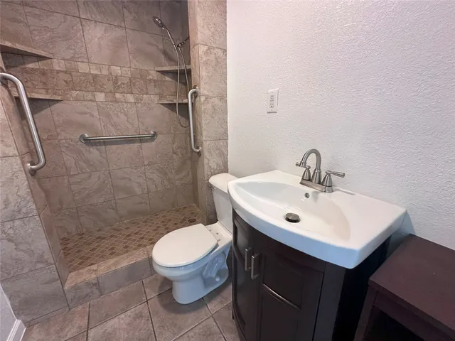 a bathroom with a sink toilet and shower