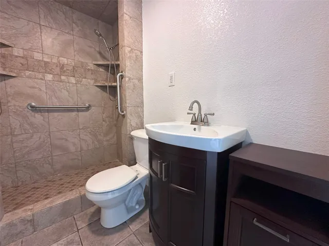 a bathroom with a sink toilet and a mirror