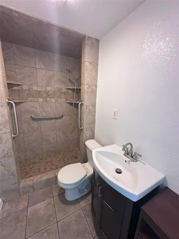 a bathroom with a sink toilet and shower