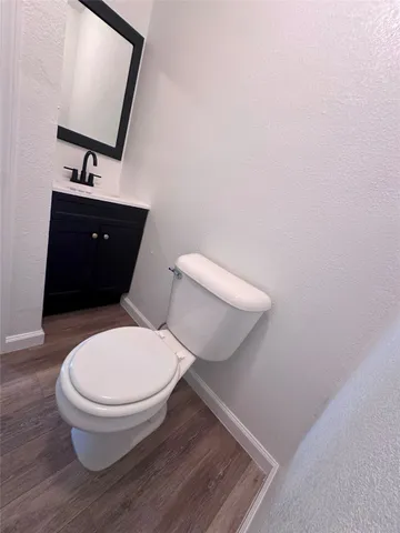 a white toilet sitting next to a bathroom sink