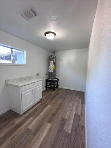 a room with a bed and cabinets