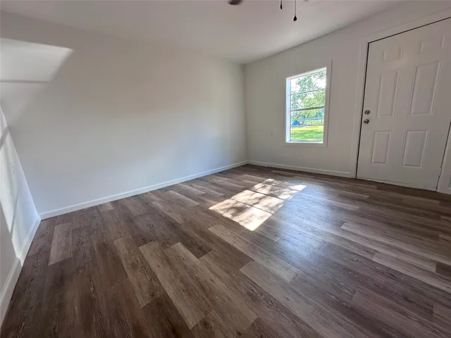 a view of wooden floor and windows in a room