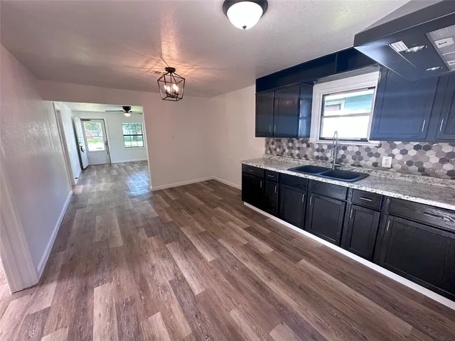 a view of a kitchen counter space and wooden floor