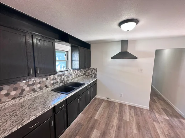 a kitchen with a sink and stove