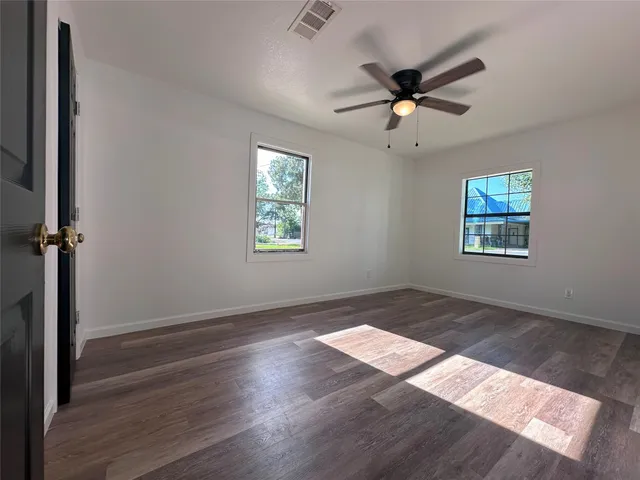wooden floor in an empty room with a window