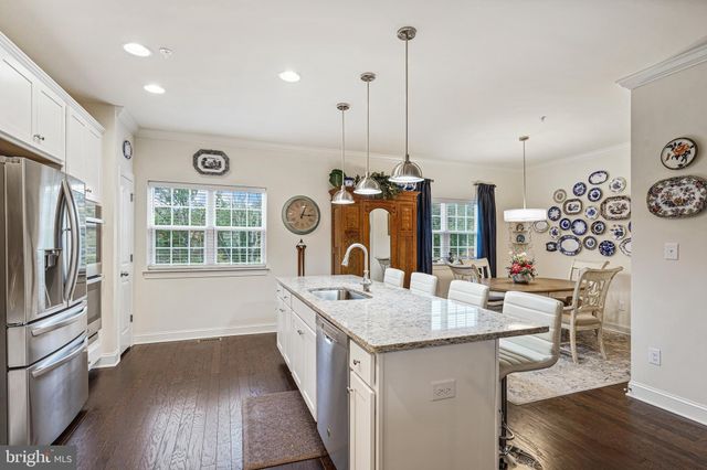 a kitchen with sink refrigerator and stove