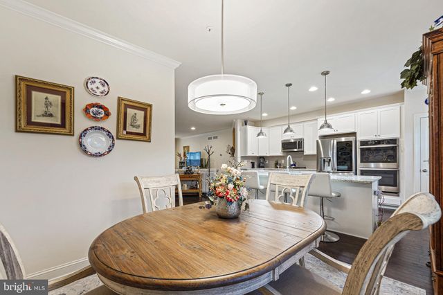 a view of a dining room with furniture wooden floor and a chandelier