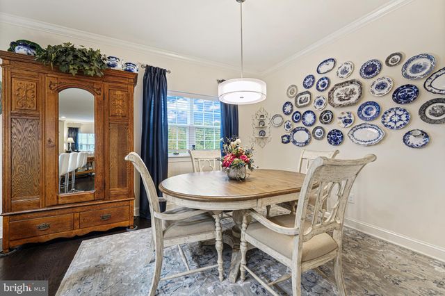 a view of a dining room with furniture and a chandelier