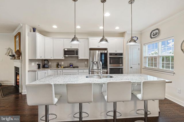 a kitchen with kitchen island granite countertop a table and chairs