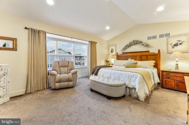 a bedroom with bed and a couch