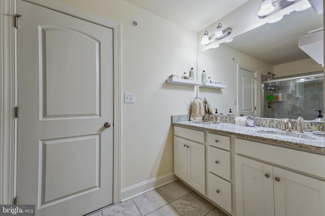 a bathroom with a double vanity sink and mirror