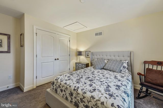 a bedroom with a large bed and a chair in it