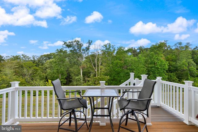 a view of an outside dining space with furniture and city view